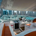 Flybridge and helm view of the Oryx fishing yacht overlooking Dubai Marina skyline