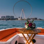 Outdoor seating area with floral arrangement on the Oryx yacht during a Dubai fishing trip